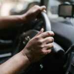 a person holding a steering wheel