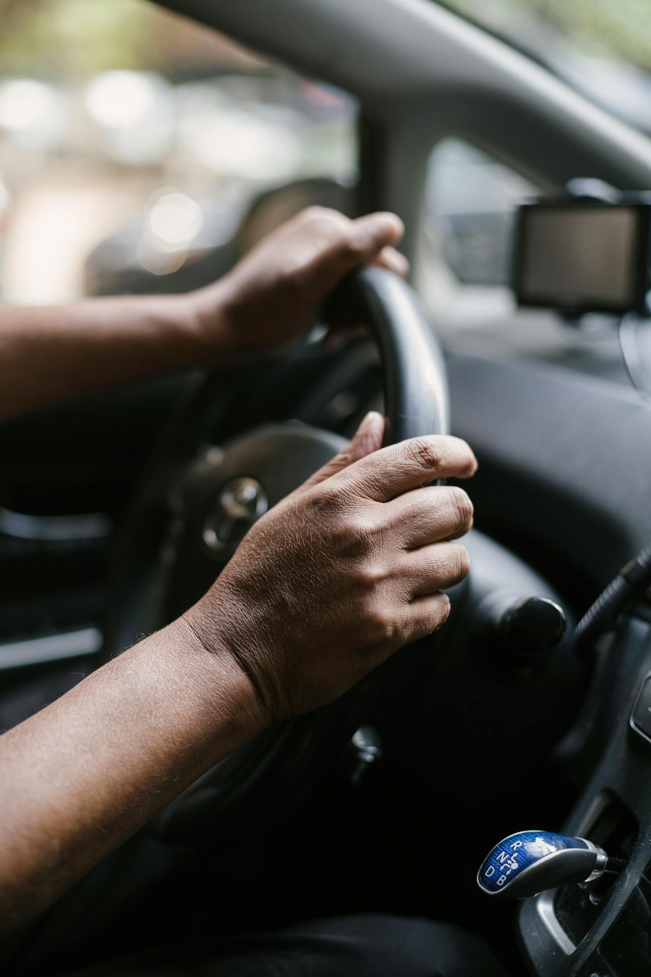 a person holding a steering wheel